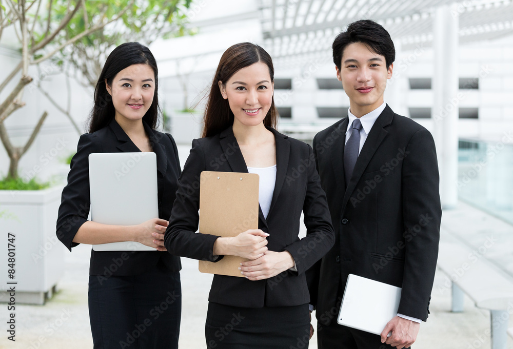 Confident business people hold with clipboard and digital device Confident business people hold with clipboard and digital device