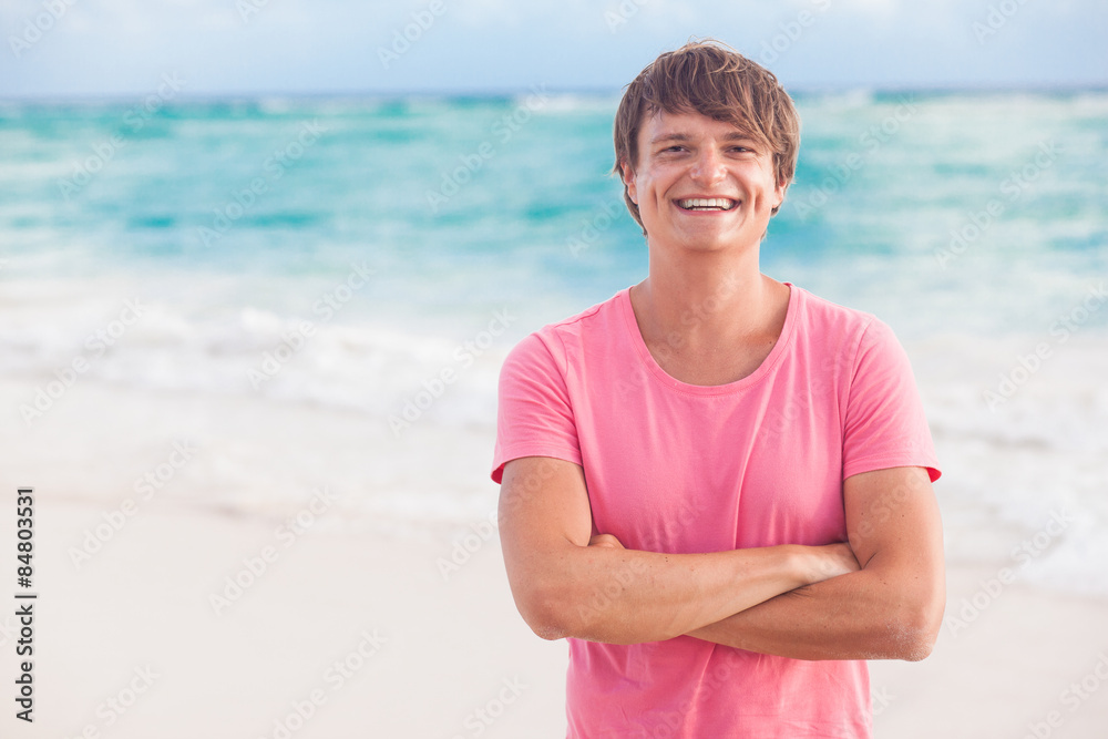 picture of a young man smiling and chilling at tropical beach picture of a young man smiling and chilling at tropical beach