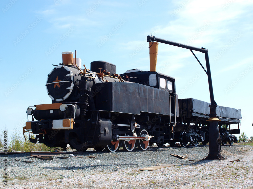 Old soviet locomotive on a background of blue sky
