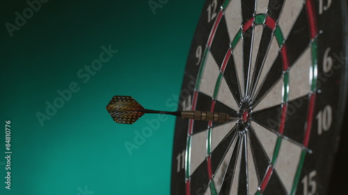 Dart hits bullseye & Dart bounces off board, slow motion photo