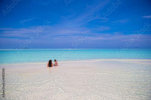 Young happy woman on white sandy beach