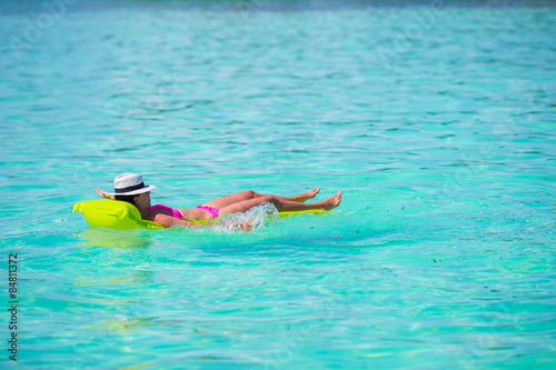 Woman relaxing on inflatable air mattress at turquoise water © travnikovstudio