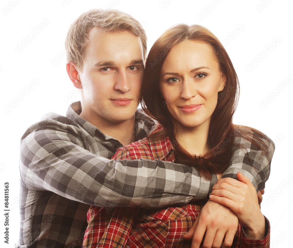 lovely happy couple hugging over grey background.