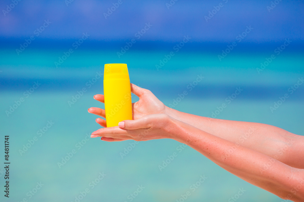 Closeup suncream bottle background blue sea Closeup suncream bottle background blue sea