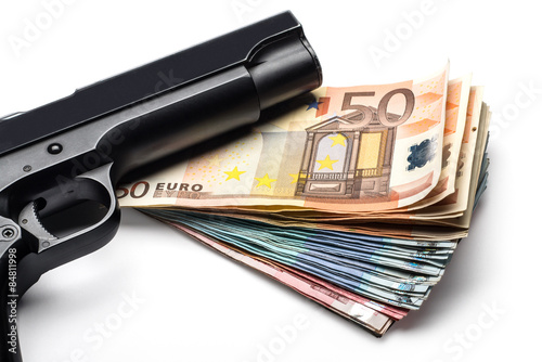 Bunch of euro banknotes with a gun