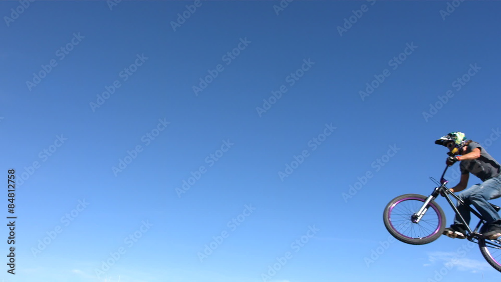 Mountain biker flies through air, slow motion Mountain biker flies through air, slow motion