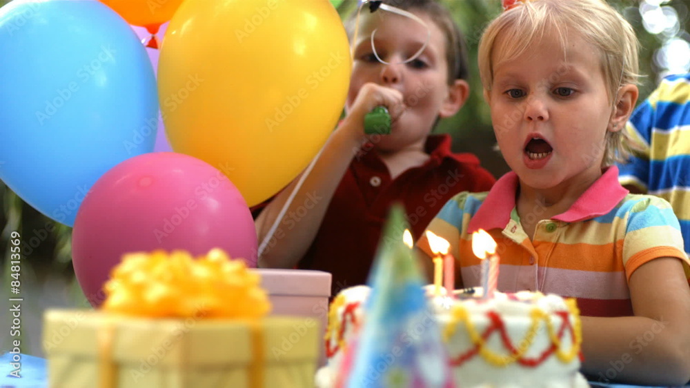 Young girl blowing out birthday candles