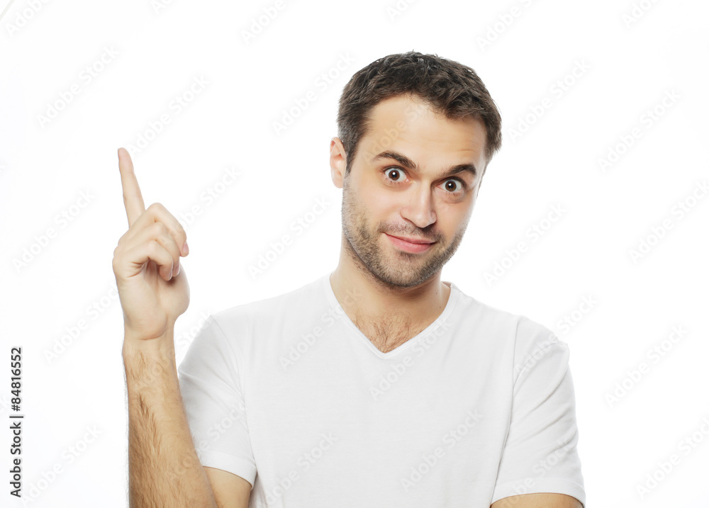 Young smiling happy man shows something Young smiling happy man shows something