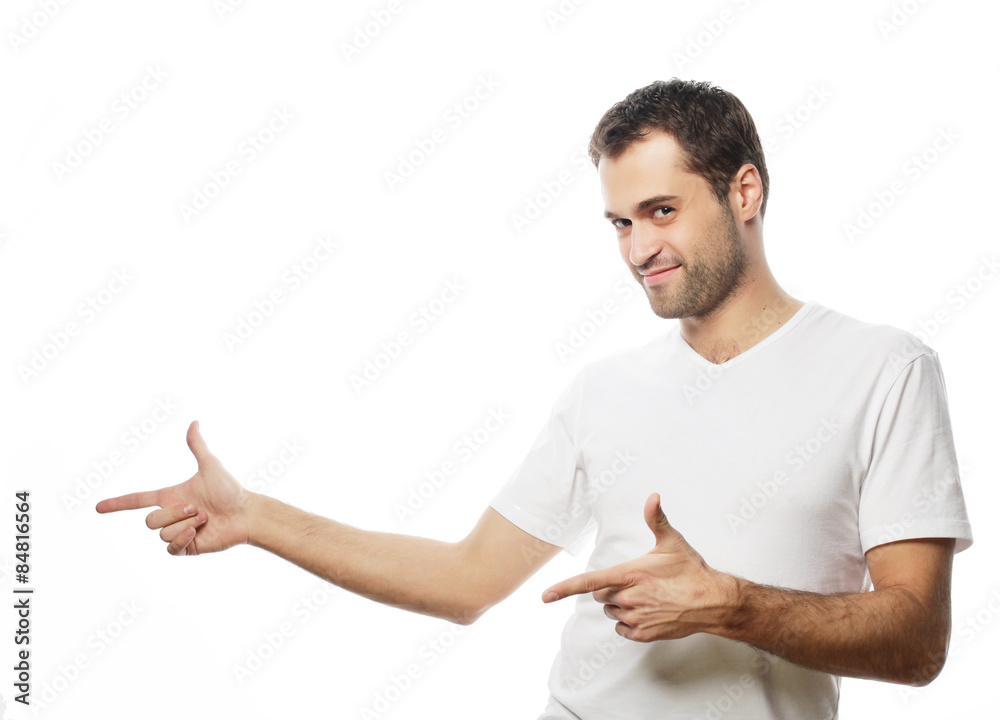 Young smiling happy man shows something
