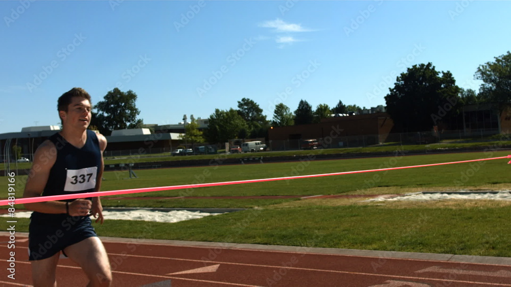 Track runner crosses finish line, slow motion Track runner crosses finish line, slow motion
