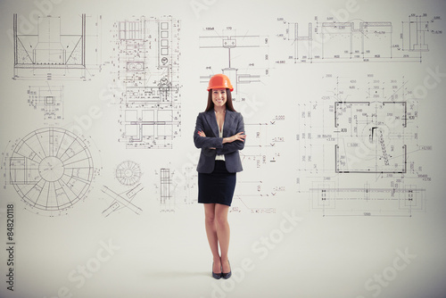 woman in hardhat over grey wall with prints