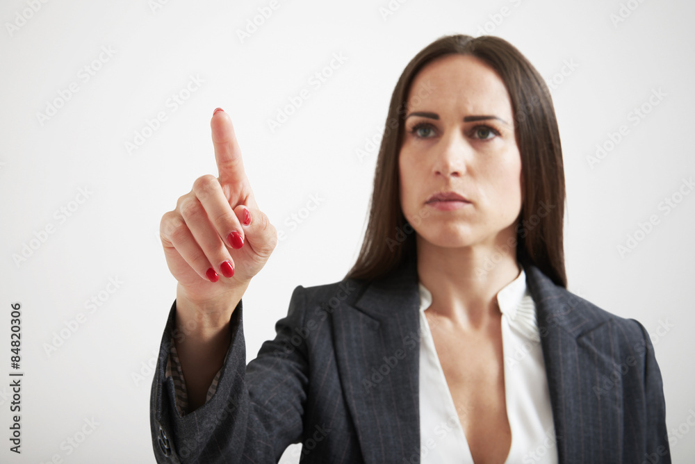 serious businesswoman holding her forefinger serious businesswoman holding her forefinger