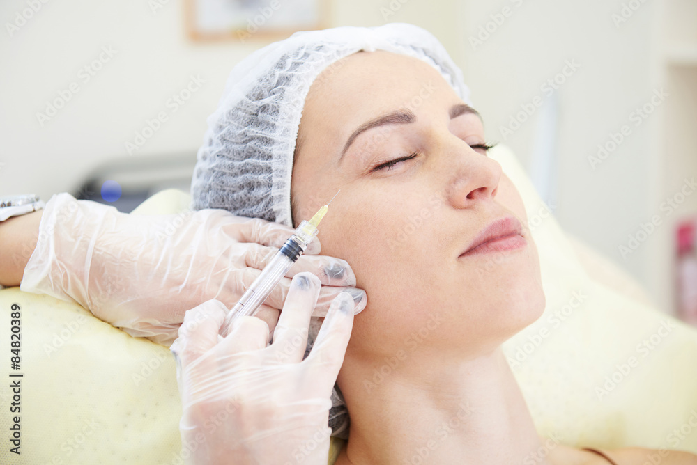 woman getting an injection in her face