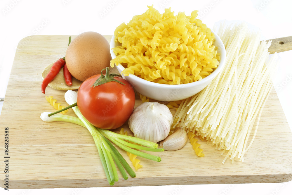 fusilli, spaghetti, garlic, chilli, onion, egg and tomato on w fusilli, spaghetti, garlic, chilli, onion, egg and tomato on w
