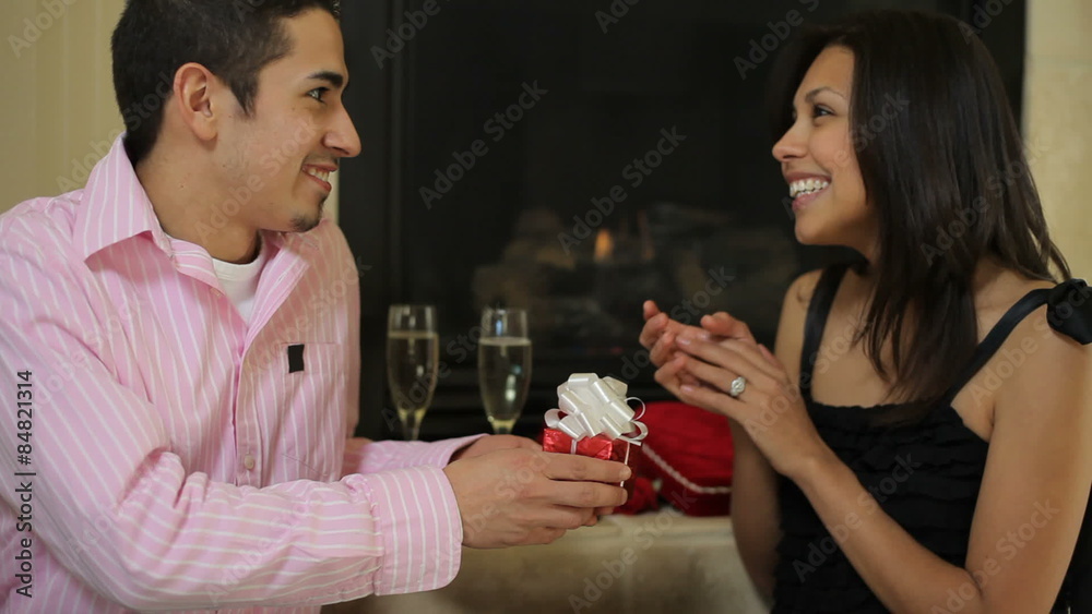 Couple exchanging gifts on Valentines day Couple exchanging gifts on Valentines day