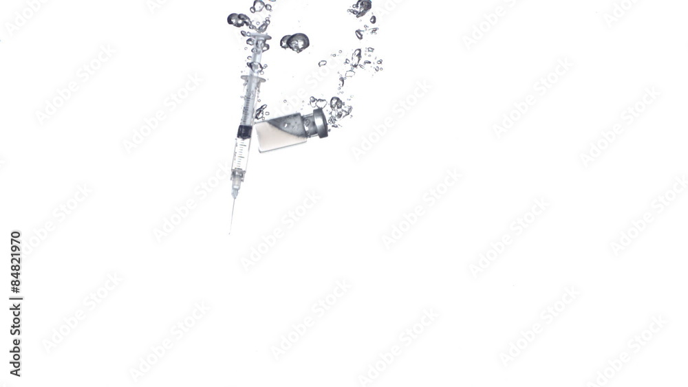 Syringe splashing into water, slow motion Syringe splashing into water, slow motion