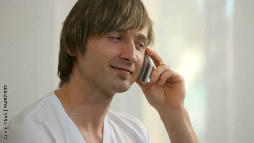 Young man talking on cell phone, closeup Young man talking on cell phone, closeup