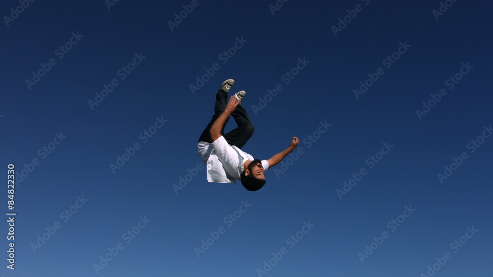 Man does a back flip in sky, slow motion Man does a back flip in sky, slow motion