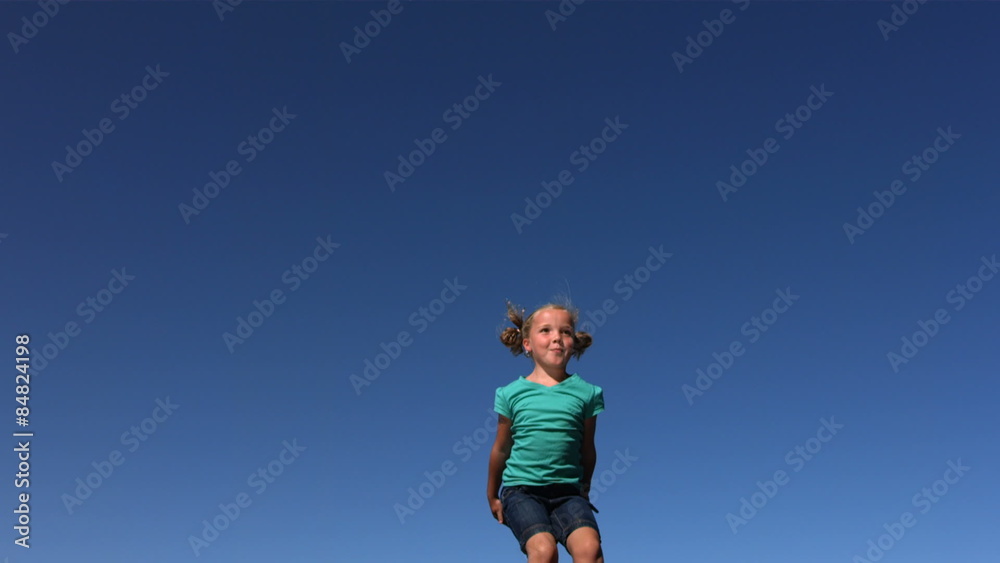 Young girl jumping on trampoline, slow motion Young girl jumping on trampoline, slow motion