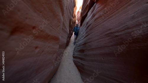 Woman Hiker Backpacker hiking narrow slot canyon