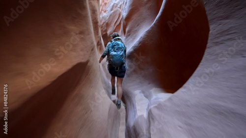 Woman Hiker Backpacker hiking narrow slot canyon