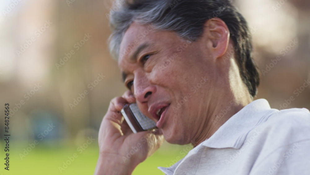 Senior Asian man talking on cell phone Senior Asian man talking on cell phone