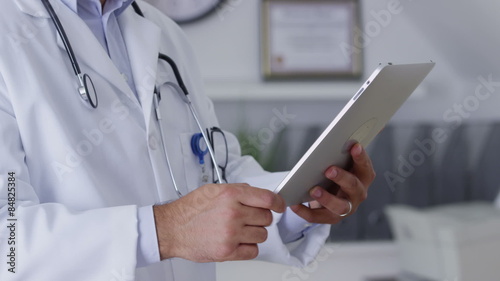 Closeup of doctor using digital tablet