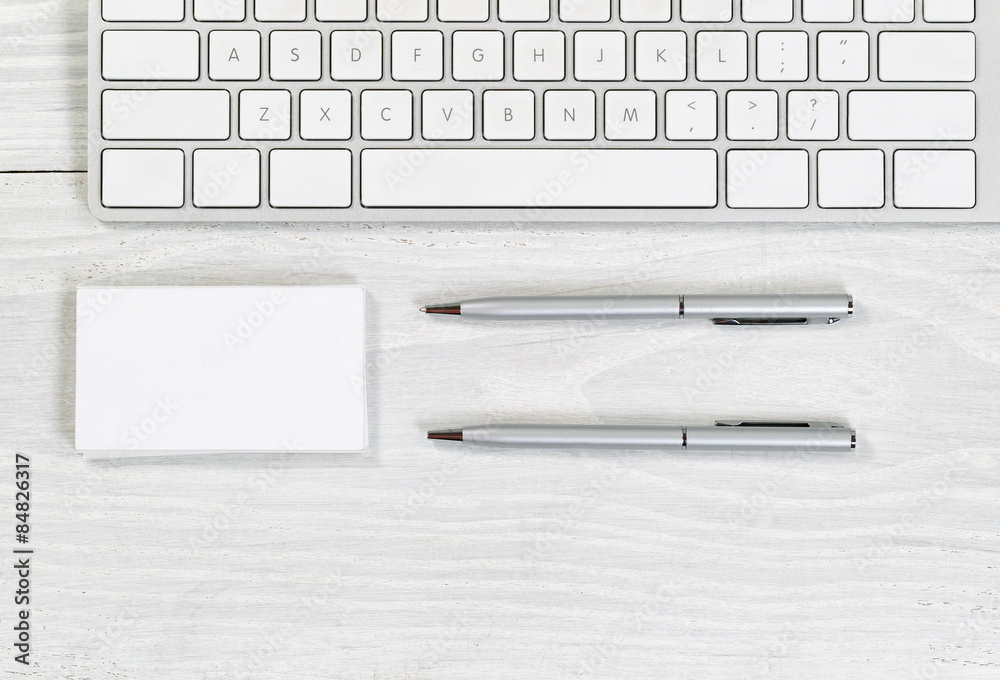 Stack of blank business cards and pens on white desktop Stack of blank business cards and pens on white desktop