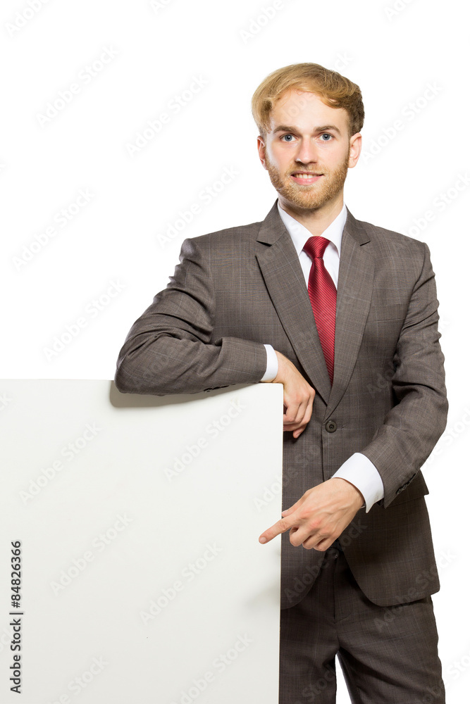 Young businessman standing while with a blank whiteboard , isola Young businessman standing while with a blank whiteboard , isola