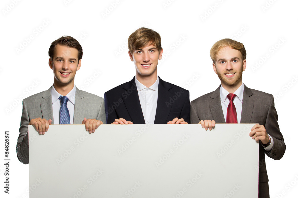 Three young businessman standing with a blank whiteboard , isola Three young businessman standing with a blank whiteboard , isola