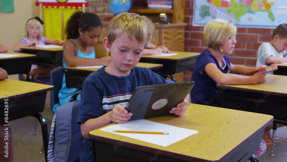 Elementary school student uses a digital tablet