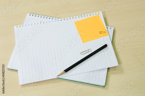 Note book paper with pencil