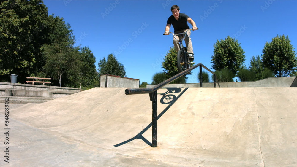 BMX rider grinds down rail, slow motion, speed ramp BMX rider grinds down rail, slow motion, speed ramp
