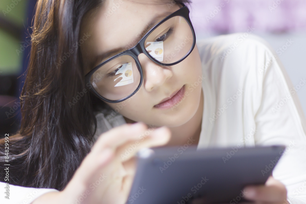 Woman using a tablet at bedroom Woman using a tablet at bedroom