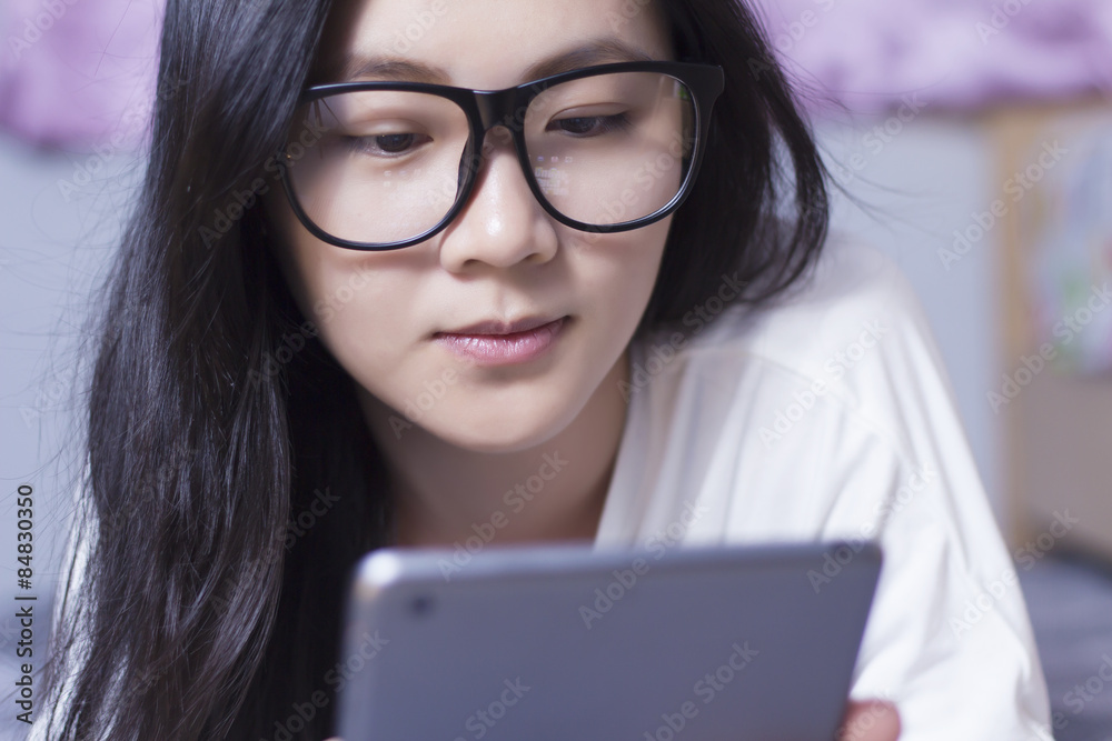 Woman using a tablet at bedroom Woman using a tablet at bedroom