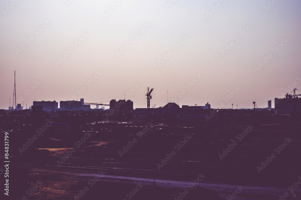 Vintage filter :Silhouette of landscape sunset scene with city b