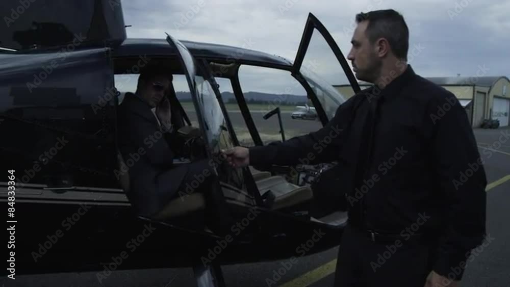 Businessman getting out of helicopter