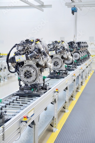 New manufactured car engines on automated production assembly line in a car factory. Manufacture of the engines for new car. New automotive engine on production line.