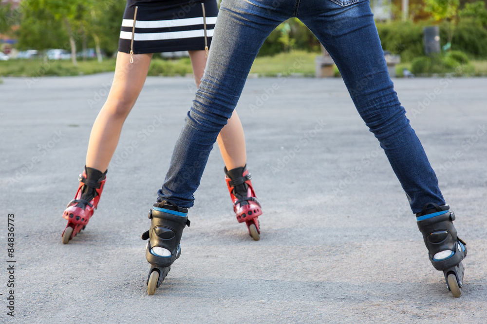 Bodies of two female skaters.
Diverse dressed legs of two slim girls skating on roller skates on paved road together
Bodies of two female skaters.
Diverse dressed legs of two slim girls skating on roller skates on paved road together