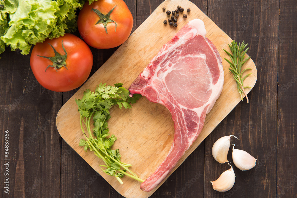Fresh Raw Pork Chops and vegetable on wooden background. Fresh Raw Pork Chops and vegetable on wooden background.