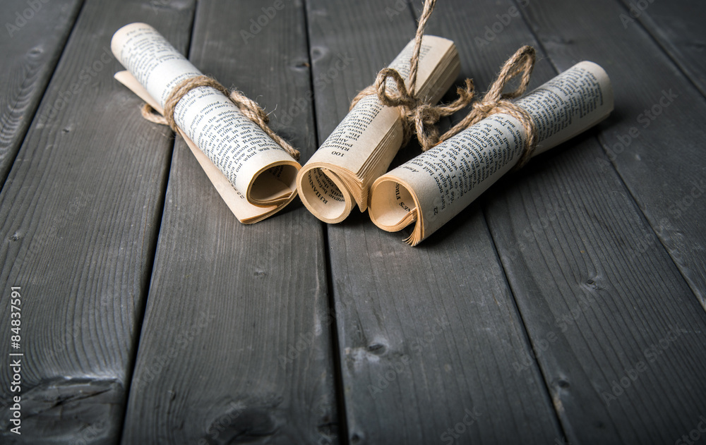 old paper rolls on wooden background