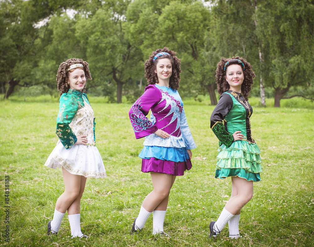Fototapeta premium Three young beautiful girls in irish dance dress posing outdoor