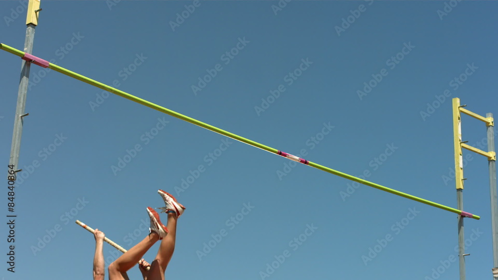 Track and Field athlete doing pole vault, slow motion