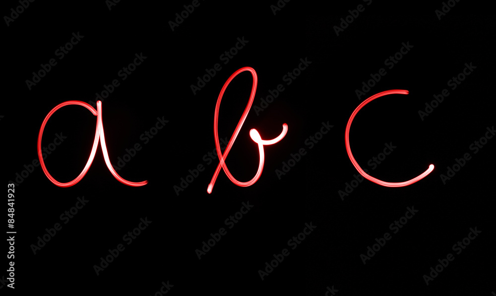 Flourescent letters 'abc' in bright red neon color