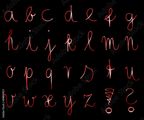 Flourescent letters of the alphabet in bright red neon color photo