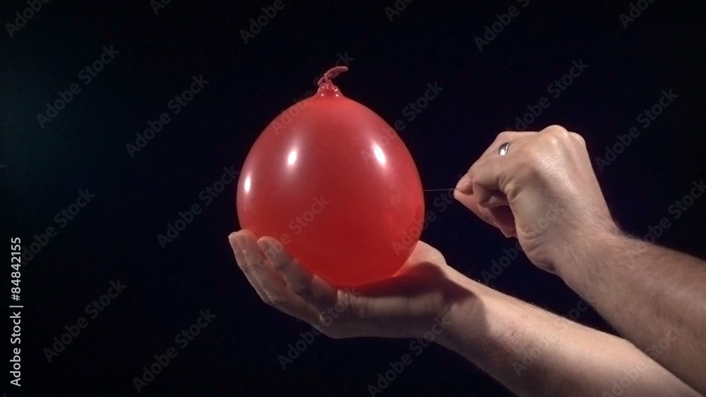 Popping water balloon in super slow motion