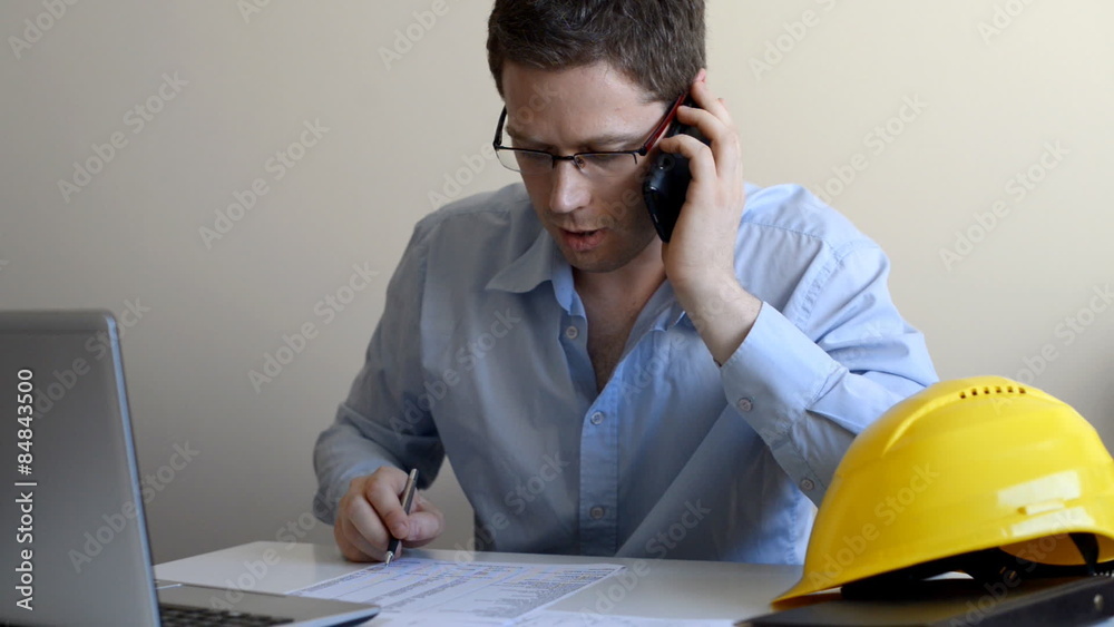 Architect talking on the phone with client.