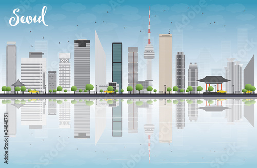 Seoul skyline with grey building, blue sky and reflections.