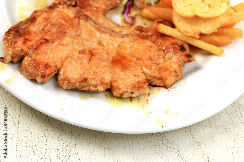 Pork chop, french fries with salad