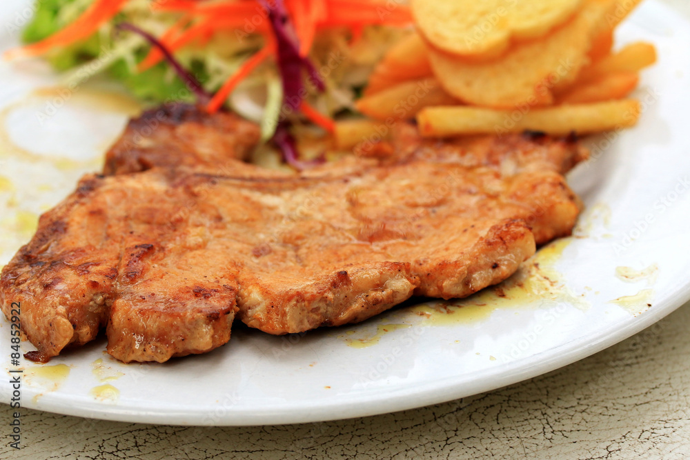 Pork chop, french fries with salad Pork chop, french fries with salad